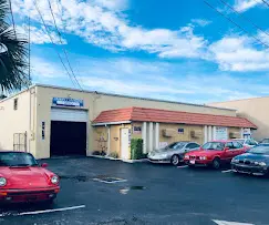 A parking lot with cars parked in front of it.